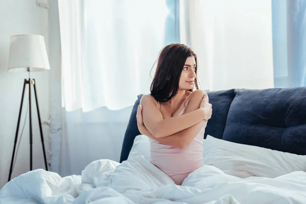 Beautiful girl looking away on bed during morning time at home — Stock Photo