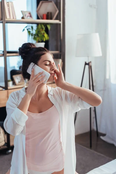 Selective focus of girl talking on smartphone during morning time at home — Stock Photo