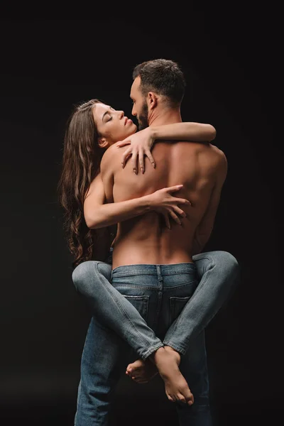 Beautiful passionate couple hugging isolated on black — Stock Photo