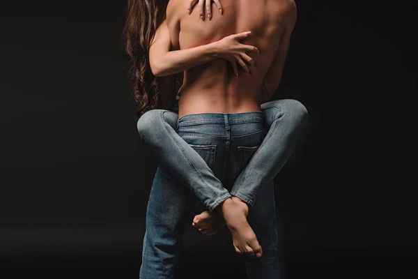 Cropped view of passionate couple hugging isolated on black — Stock Photo