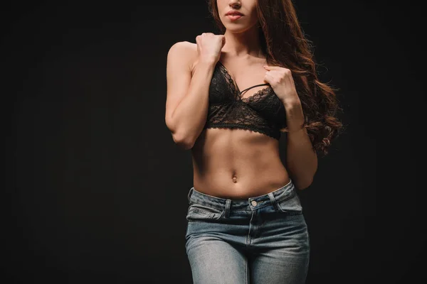 Cropped view of girl posing in lace bra isolated on black — Stock Photo