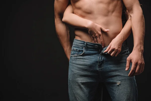 Cropped view of passionate girl hugging sexual shirtless man isolated on black — Stock Photo