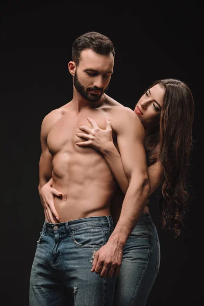 Erotic couple hugging isolated on black — Stock Photo