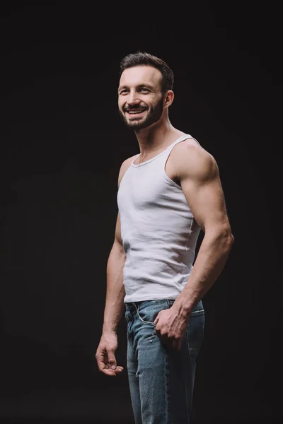 Sexy cheerful man posing isolated on black — Stock Photo