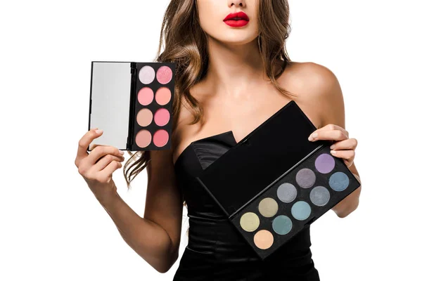 Cropped view of girl with red lips holding palettes with eyeshadows isolated on white — Stock Photo