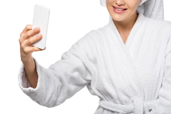 Cropped view of girl in bathrobe taking selfie isolated on white — Stock Photo