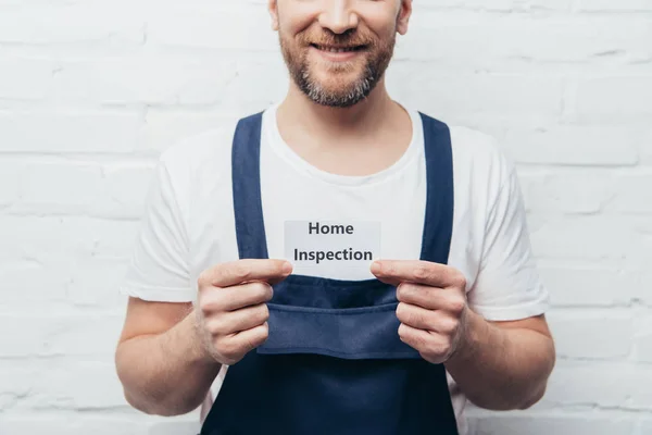Partial view of male craftsman showing card with lettering home inspection — Stock Photo