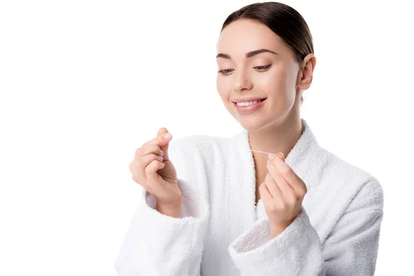 Smiling woman in white bathrobe with dental floss isolated on white — Stock Photo