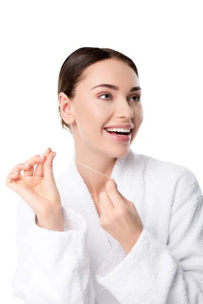 Femme gaie en peignoir blanc avec fil dentaire isolé sur blanc — Photo de stock