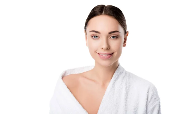 Attractive smiling woman in bathrobe looking at camera isolated on white — Stock Photo