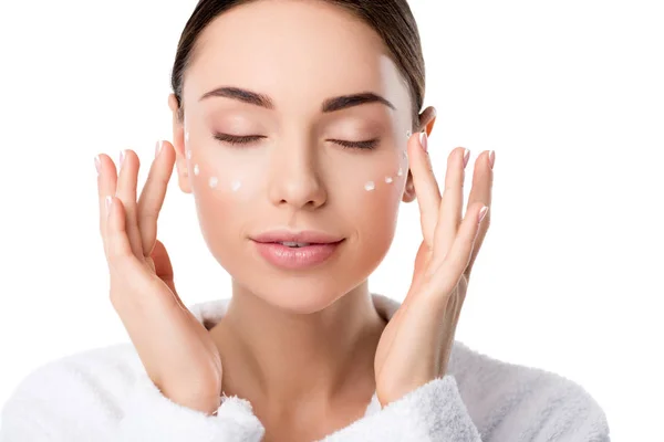 Beautiful woman with eyes closed applying moisturizing face cream isolated on white — Stock Photo