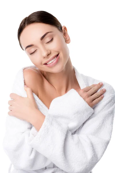 Schöne lächelnde Frau im Bademantel mit verschränkten Händen und geschlossenen Augen isoliert auf weiß — Stockfoto