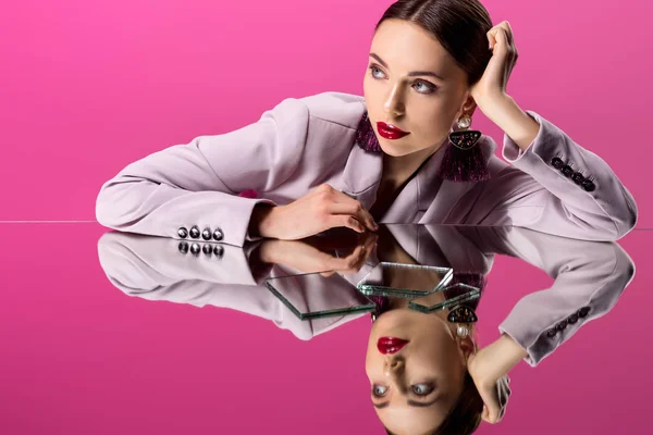 Beautiful glamorous woman in formal wear reflecting in mirrors isolated on pink — Stock Photo