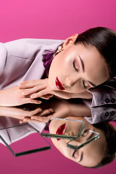 Stylish glamorous woman in formal wear with eyes closed reflecting in mirrors isolated on pink — Stock Photo