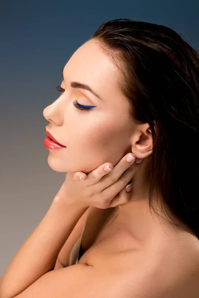 Portrait of beautiful woman with glamorous makeup touching face — Stock Photo