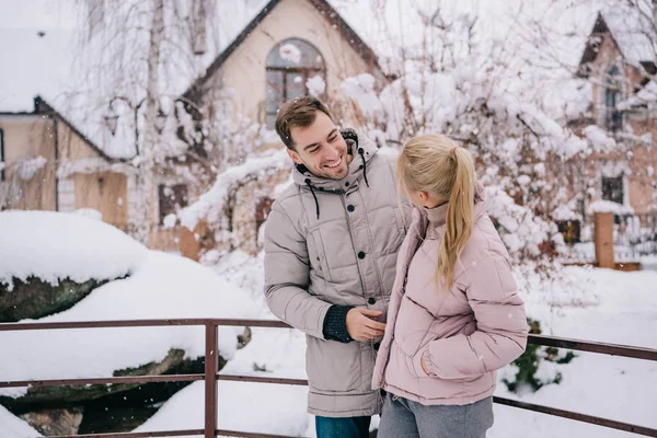 Handsome man looking at blonde girlfriend and smiling in winter — Stock Photo