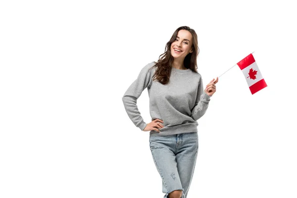 Smiling woman in grey casual clothes holding canadian flag isolated on white — Stock Photo