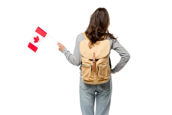 Vista posterior de una alumna con bandera canadiense y mano sobre cadera aislada sobre blanco - foto de stock