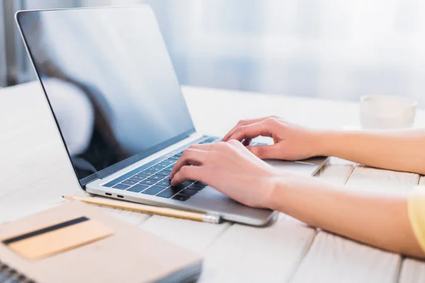 Cropped view of woman typing on laptop at home — Stock Photo