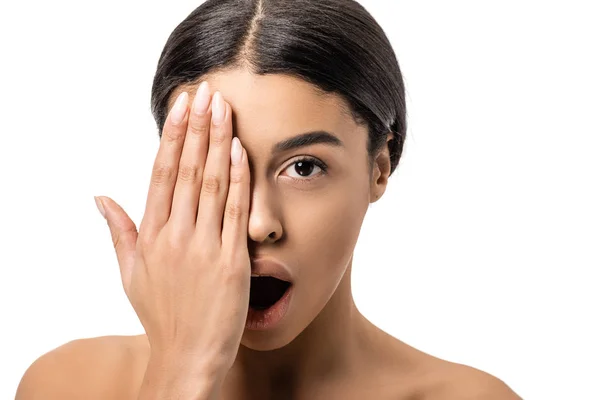 Schockierte junge afrikanisch-amerikanische Frau mit offenem Mund, die Augen mit der Hand schließt und isoliert auf weiß in die Kamera schaut — Stockfoto