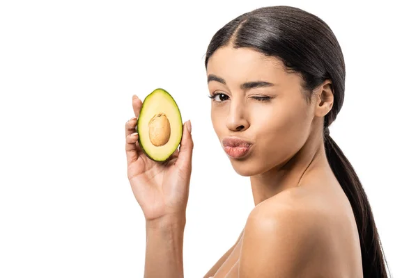 Beautiful naked african american woman holding avocado and winking at camera isolated on white — Stock Photo