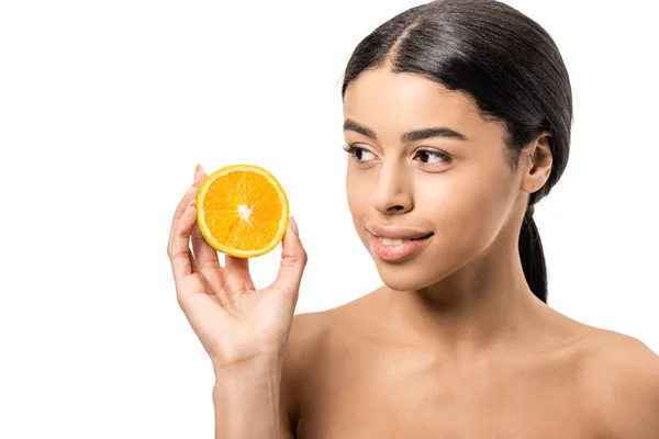 Attractive smiling naked african american girl holding halved orange isolated on white — Stock Photo