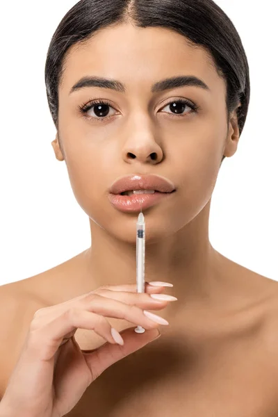 Attractive african american girl doing beauty injection in lips and looking at camera isolated on white — Stock Photo