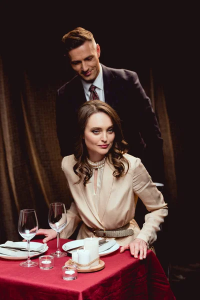 Beautiful couple in formal wear during romantic dinner in restaurant — Stock Photo