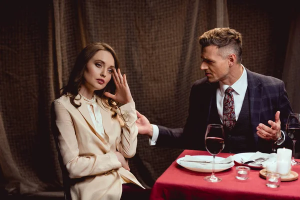 Couple quarreling while having romantic date in restaurant — Stock Photo