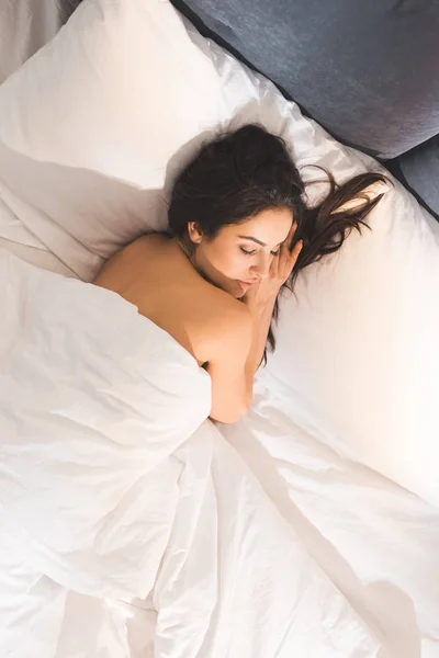Hermosa mujer desnuda durmiendo en la cama en casa por la mañana - foto de stock