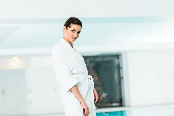 Attractive woman in bathrobe standing in spa — Stock Photo