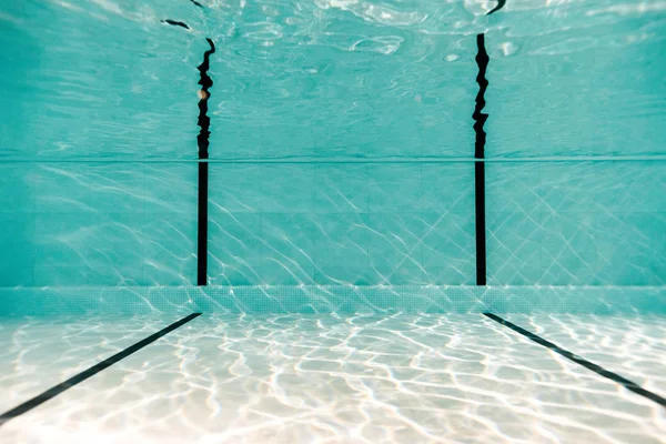 Underwater in empty swimming pool with blue water — Stock Photo