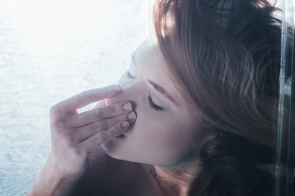 Крупним планом молода дівчина позує під водою з закритими очима і носом — стокове фото