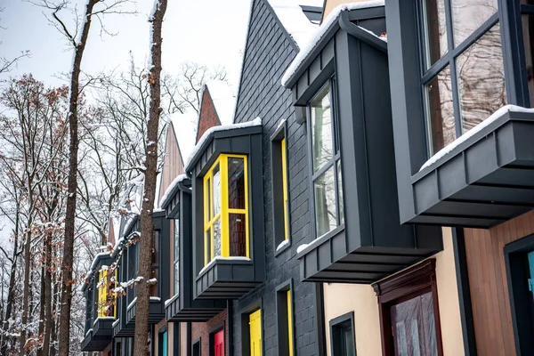 Stylish modern buildings with snow on roofs in winter — Stock Photo