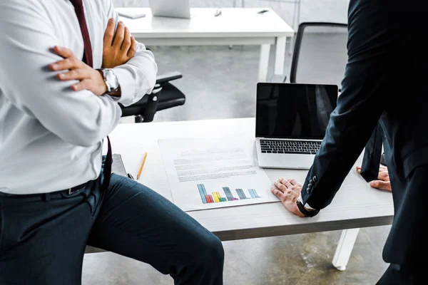 Cropped view of businessman standing with crossed arms near coworker — Stock Photo