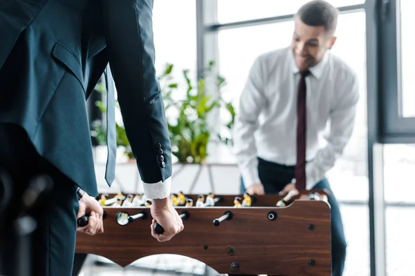 Selective focus of businessmen playing table football in modern office — Stock Photo