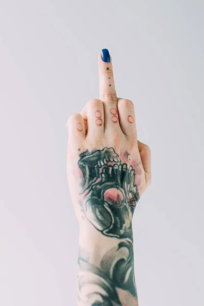 Vista ritagliata di donna con tatuaggi che mostrano il dito medio isolato sul grigio — Foto stock