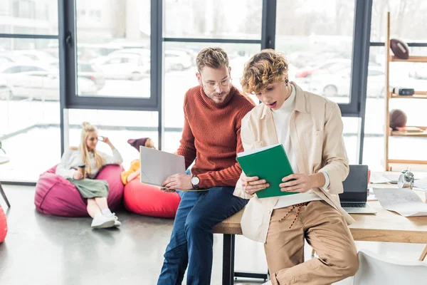 Handsome casual businessmen with notebooks working on startup project in loft office — Stock Photo