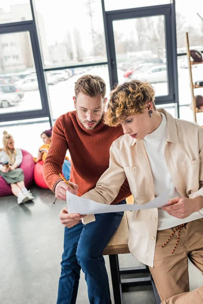 Handsome male architects working on blueprint in loft office — Stock Photo