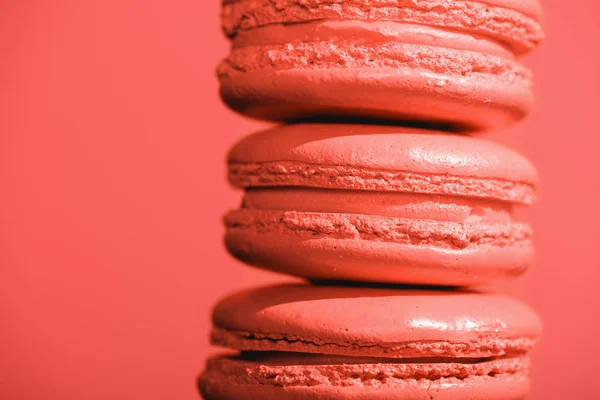 Close up of sweet macaroons on Living coral background. Pantone color of the year 2019 concept — Stock Photo