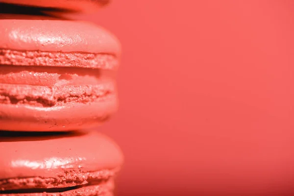 Close up of Living coral macaroons on red background. Pantone color of the year 2019 concept — Stock Photo