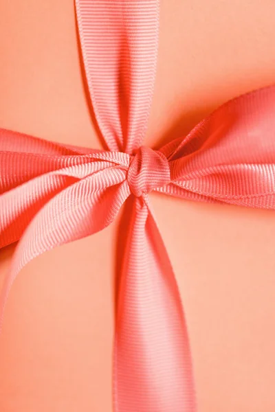 Close up of birthday gift in living coral color. Pantone color of the year 2019 concept — Stock Photo