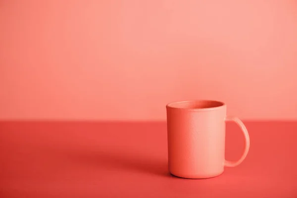 Cup of coffee on living coral background. Pantone color of the year 2019 concept — Stock Photo