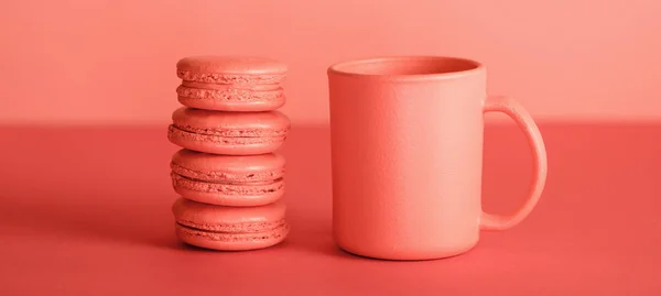 Taza de café y macarrones en color coral vivo. Pantone color del año 2019 concepto - foto de stock