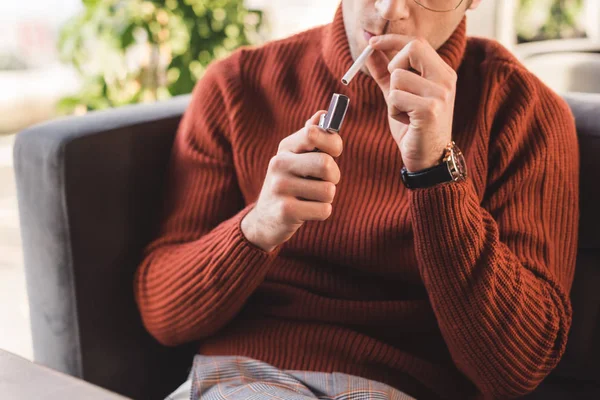 Cropped view of man smoking cigarette in cafe — Stock Photo