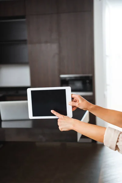 Selective focus of woman pointing at blank screen of digital tablet — Stock Photo