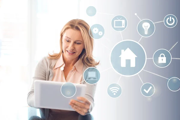 Pretty blonde woman using digital tablet, smart home concept — Stock Photo