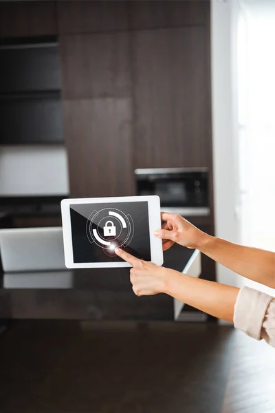 Selective focus of digital tablet with smart home security lock illustration in female hands — Stock Photo