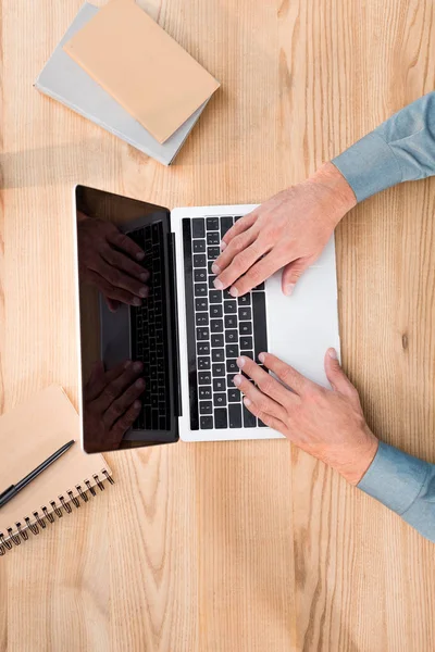 Top view of male hands typing on laptop keyboard in office — Stock Photo