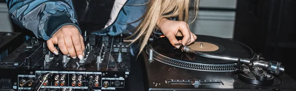 Panoramic shot of dj woman standing near dj mixer and vinyl record — Stock Photo